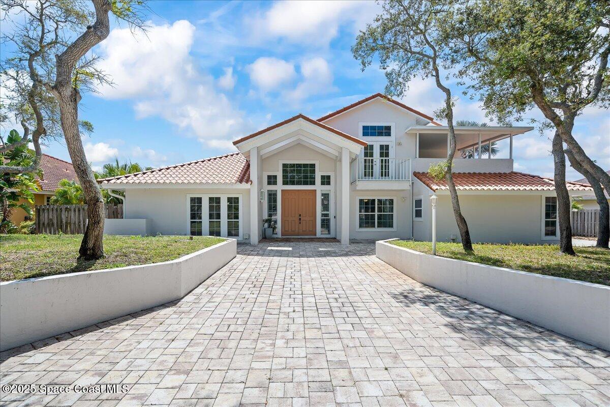 505 Sanderling Drive Indialantic, FL 32903 - Photo 63 of 63 a front view of a house with a yard and garage