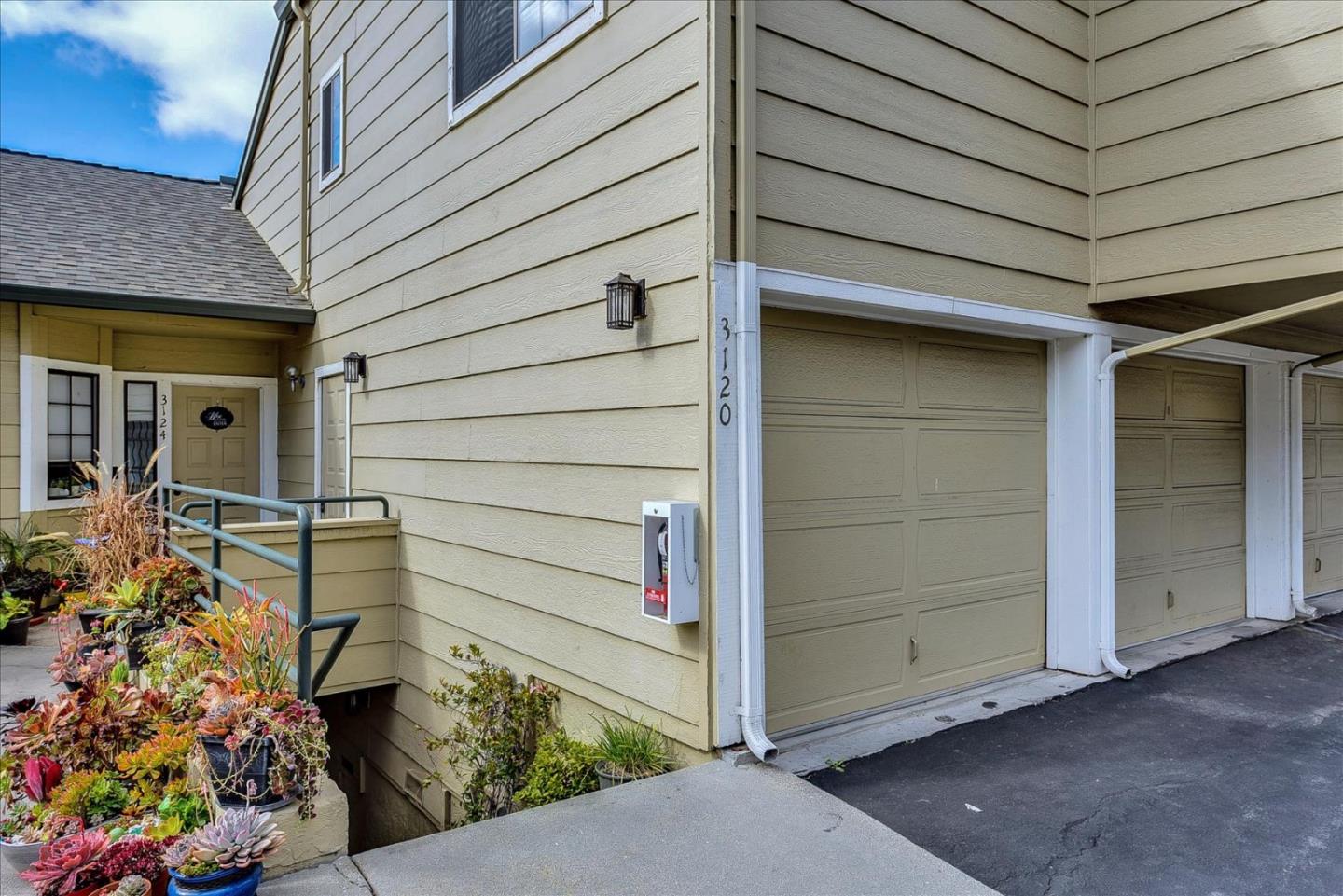 a view of front door and potted plants