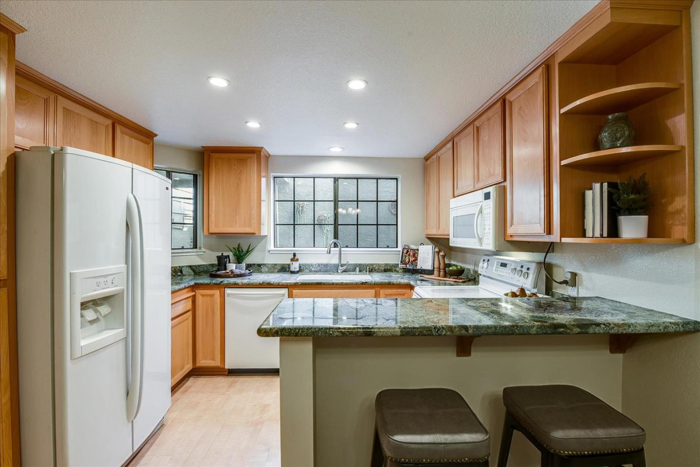 3120 Heather Ridge Drive San Jose, CA 95136 - Photo 12 of 25 a kitchen with stainless steel appliances granite countertop a sink and a refrigerator
