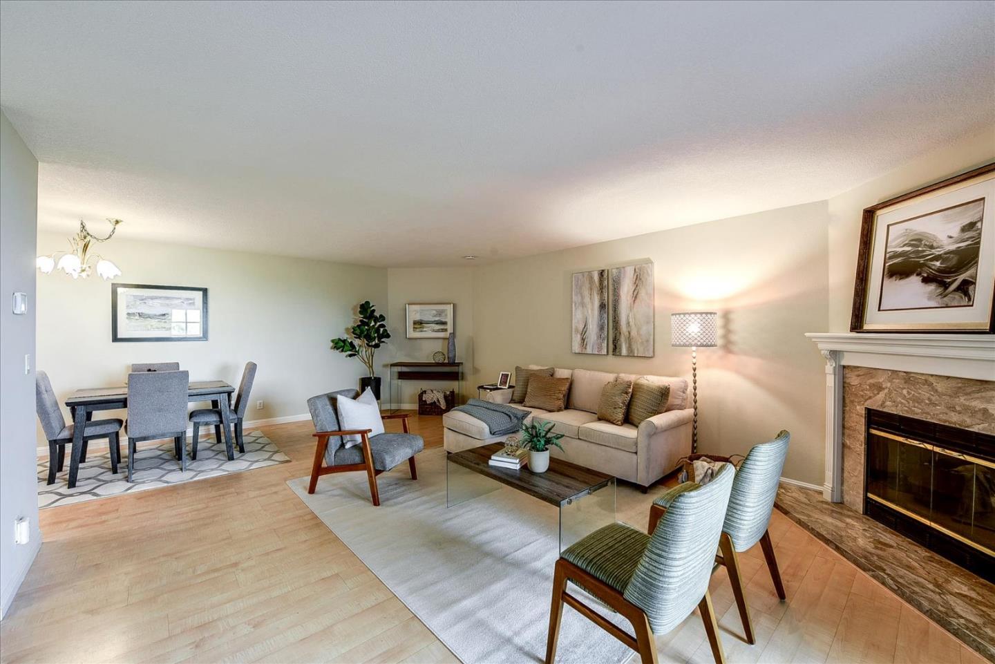 3120 Heather Ridge Drive San Jose, CA 95136 - Photo 5 of 25 a living room with furniture a fireplace and a table