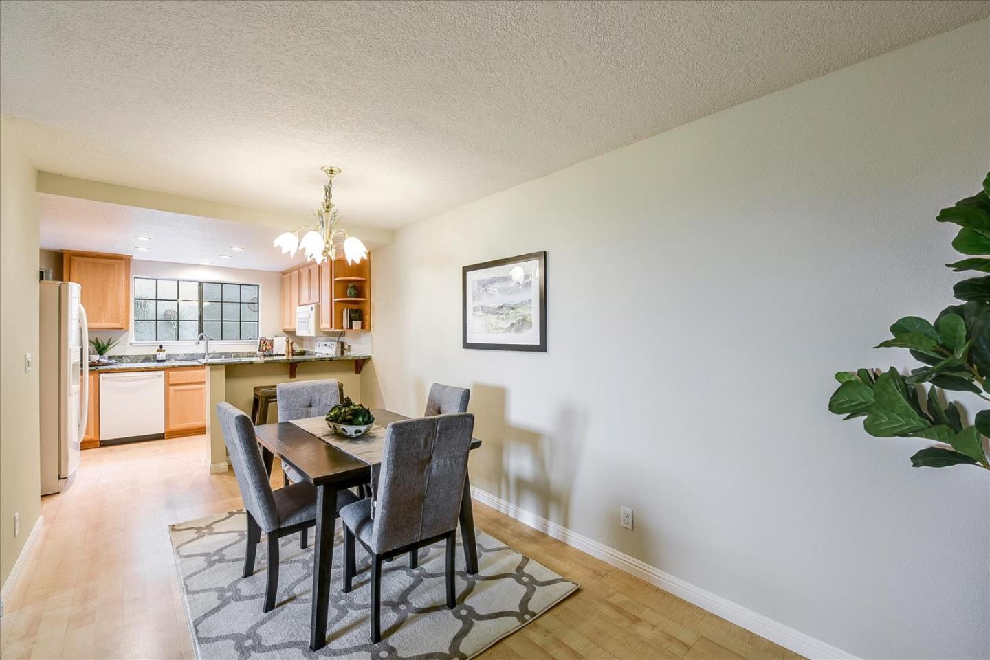 3120 Heather Ridge Drive San Jose, CA 95136 - Photo 10 of 25 a view of a dining room with furniture and a chandelier