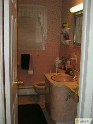 105 Dover Road Colonia, NJ 07067 - Photo 6 of 8 a bathroom with a sink a toilet and mirror