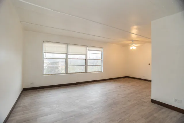 an empty room with windows and closet