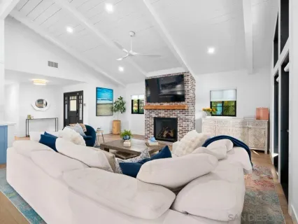 a living room with fireplace furniture and a flat screen tv