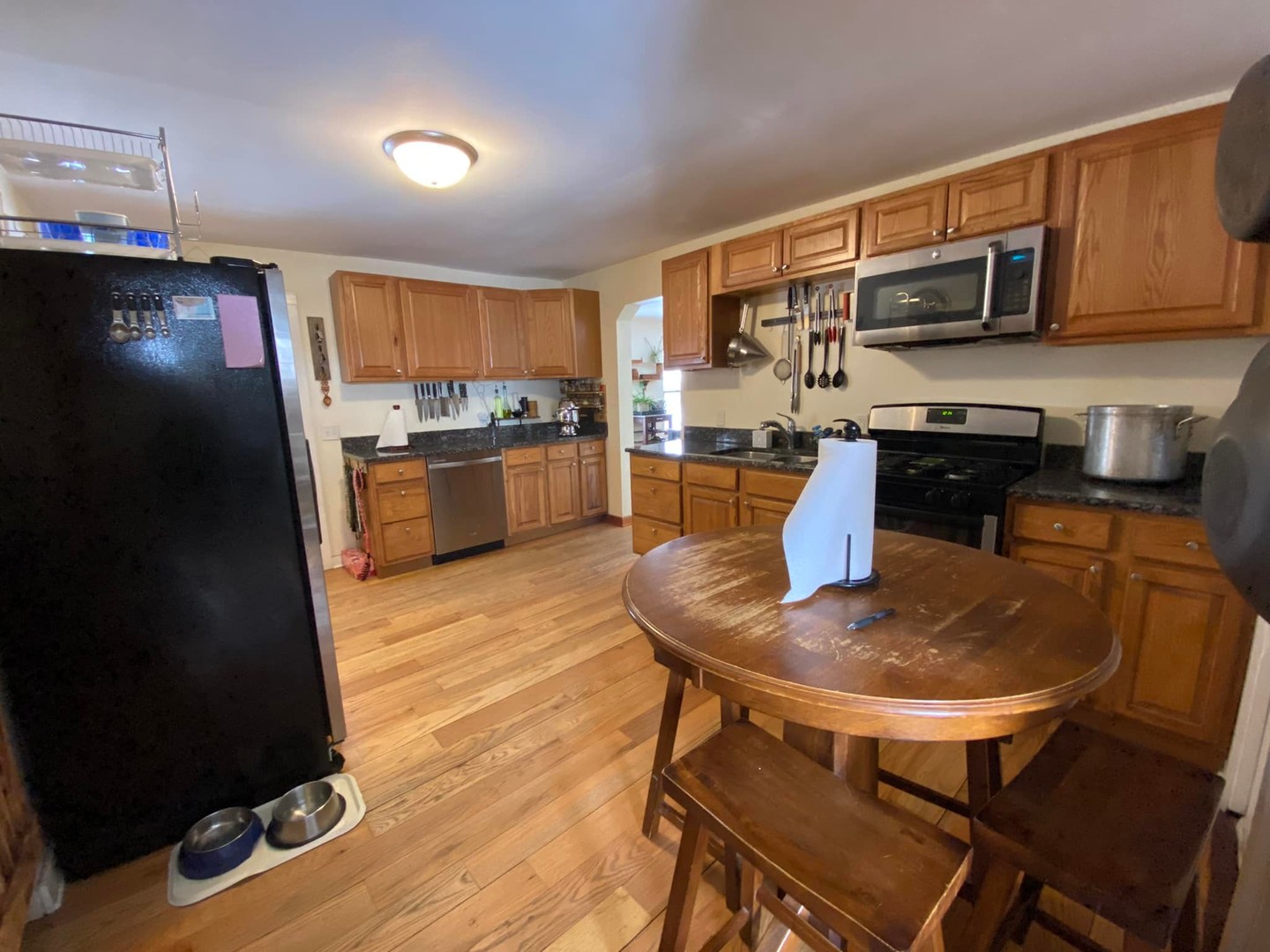 211 State Street Maple Park, IL 60151 - Photo 6 of 19 a kitchen with stainless steel appliances kitchen island granite countertop a sink and cabinets