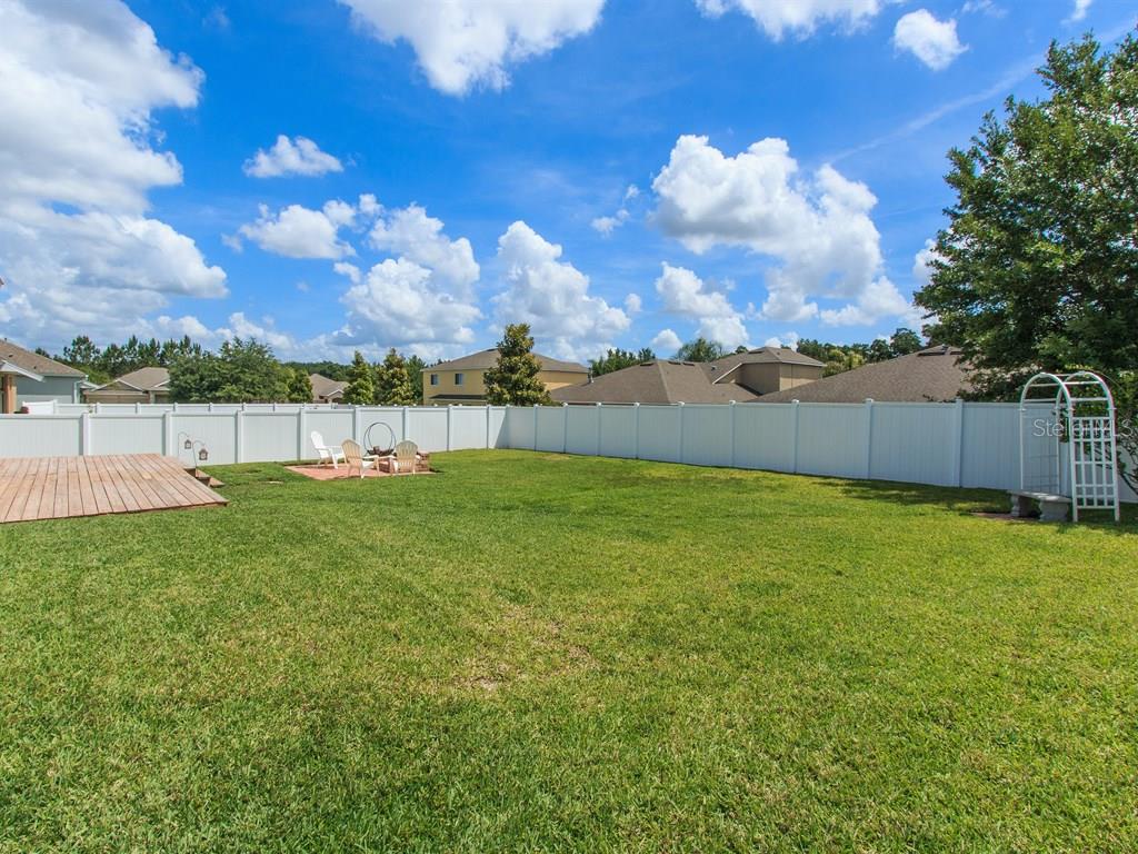 5477 Rishley Run Way Mount Dora, FL 32757 - Photo 24 of 25 a view of yard with swimming pool and wooden fence