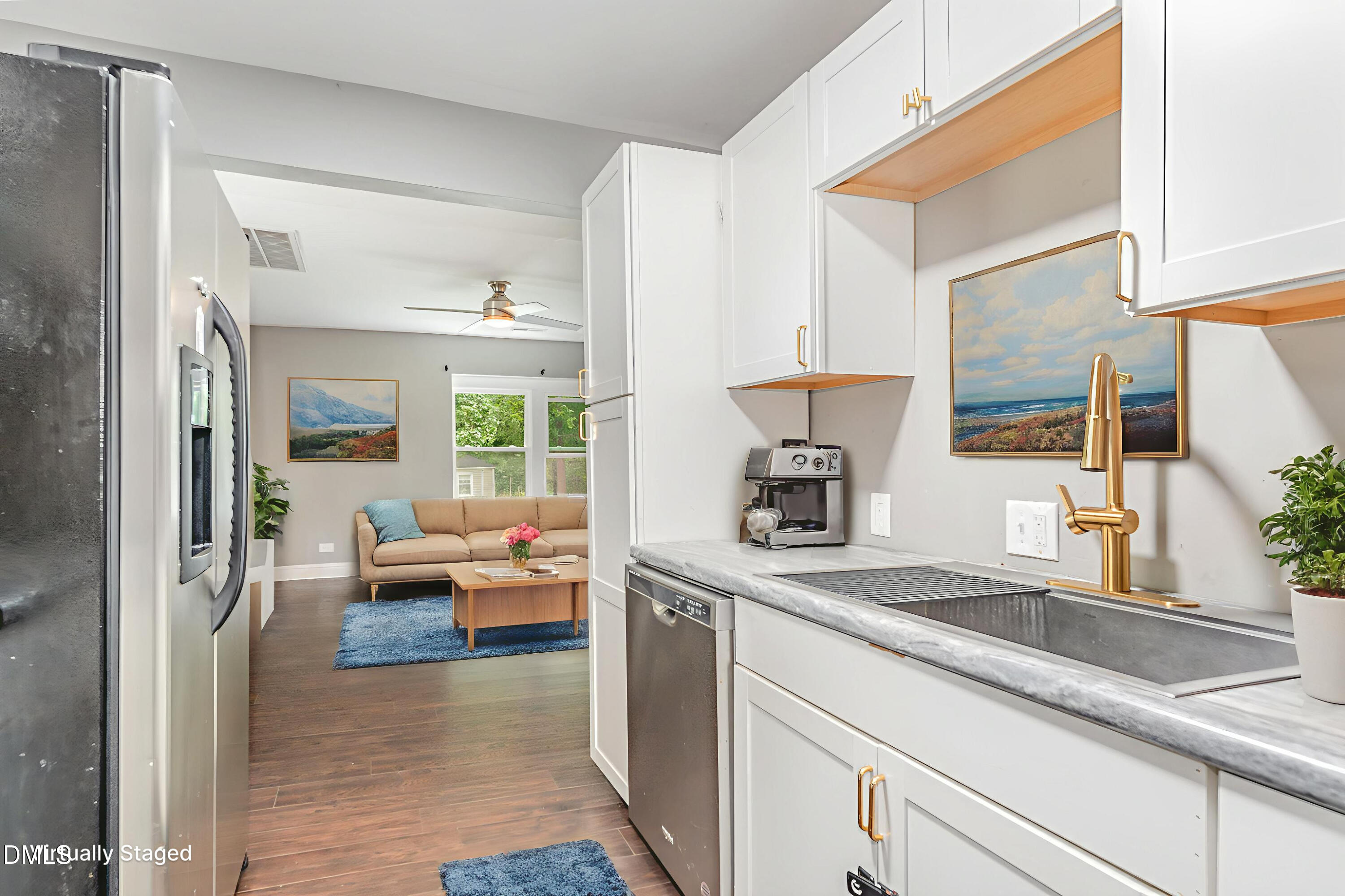 1401 Robinhood Road Durham, NC 27701 - Photo 15 of 38 a hallway with view of living room couch and a large window with wooden floor