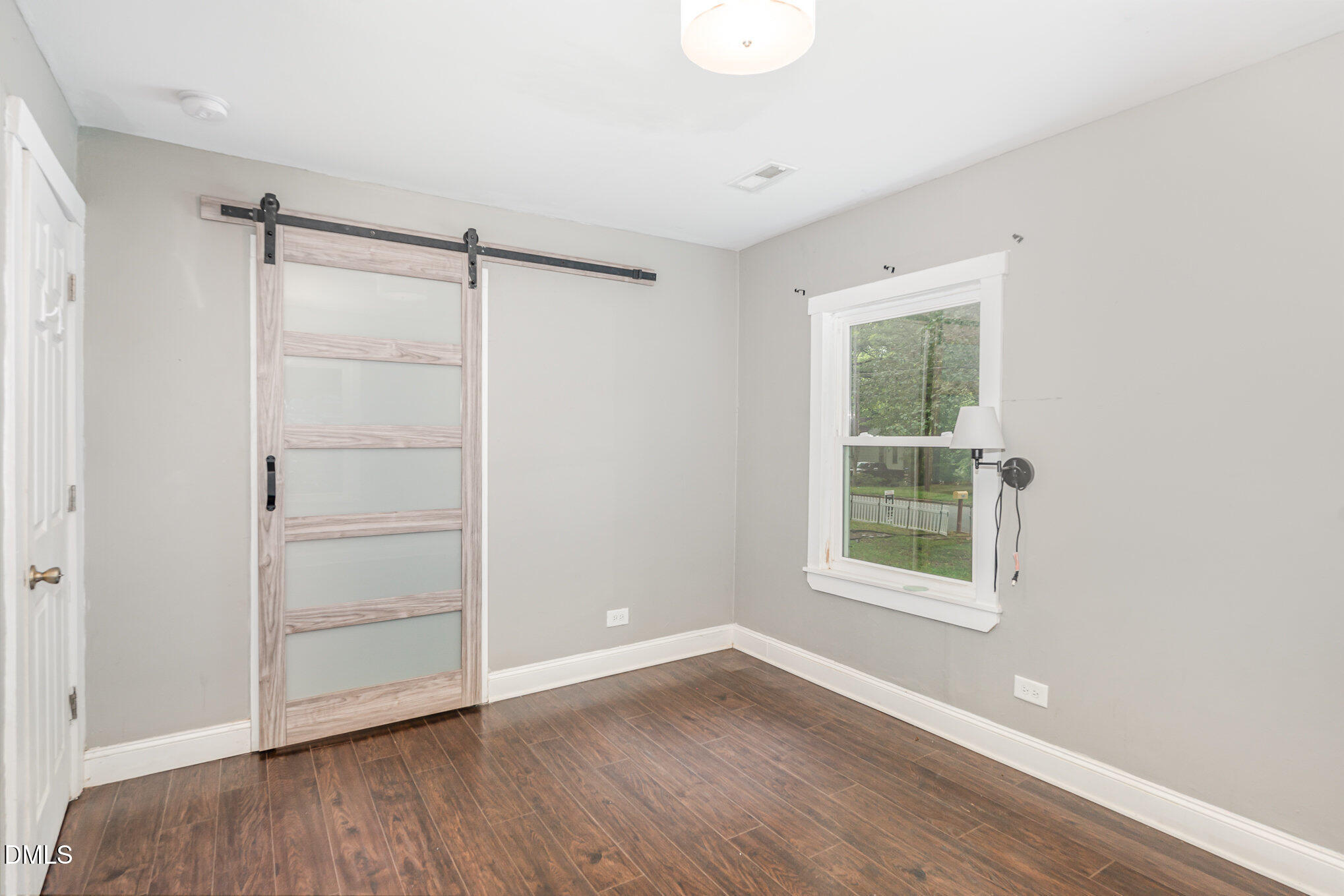 1401 Robinhood Road Durham, NC 27701 - Photo 26 of 38 an empty room with wooden floor and windows