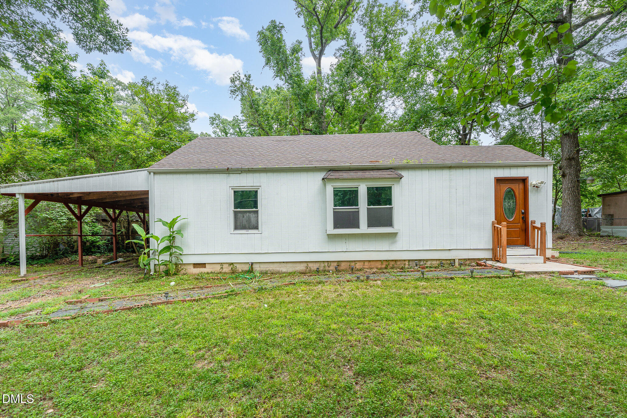 1401 Robinhood Road Durham, NC 27701 - Photo 2 of 38 a backyard of a house with table and chairs