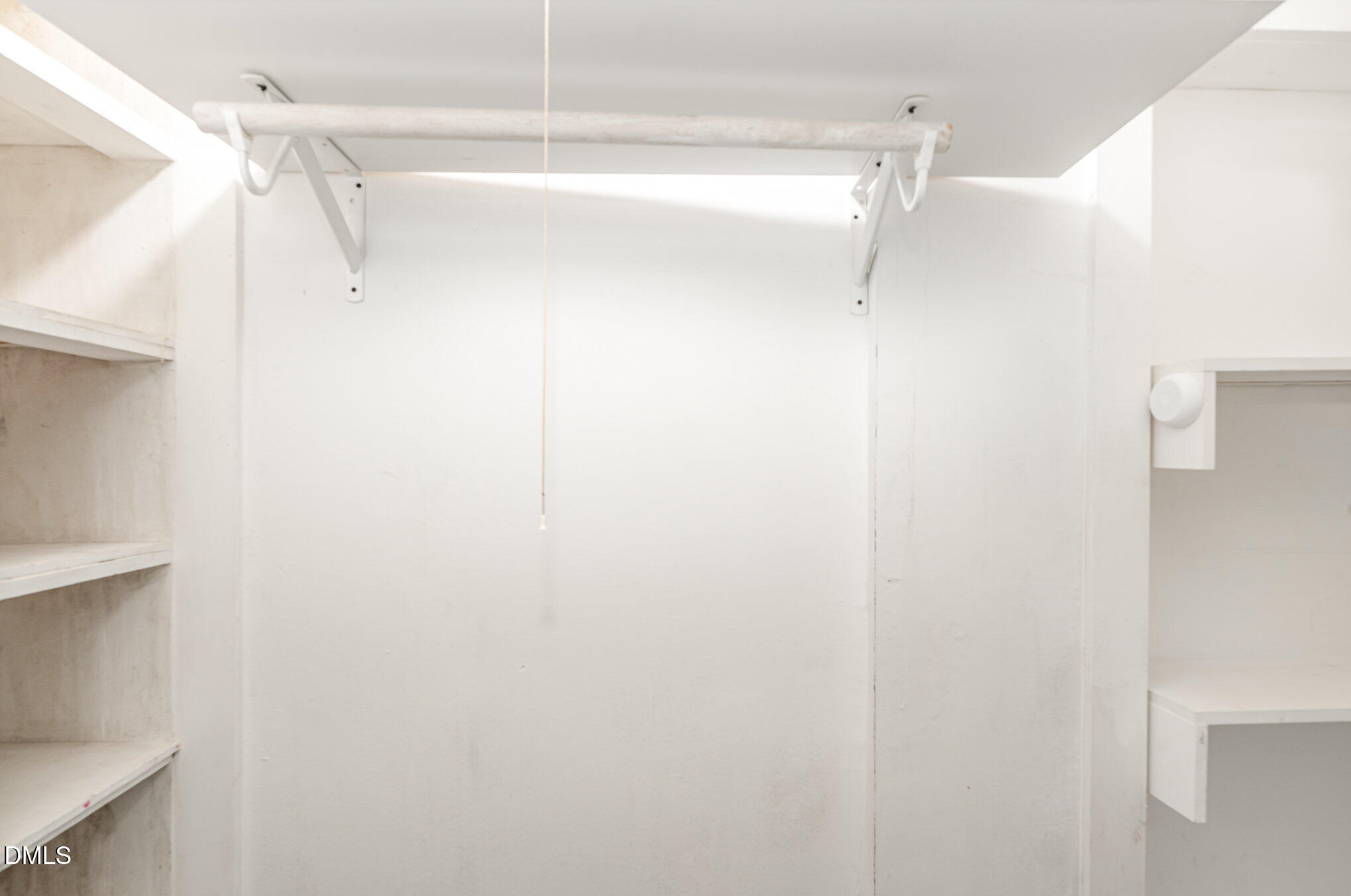 1401 Robinhood Road Durham, NC 27701 - Photo 34 of 38 a view of walk in closet with empty racks