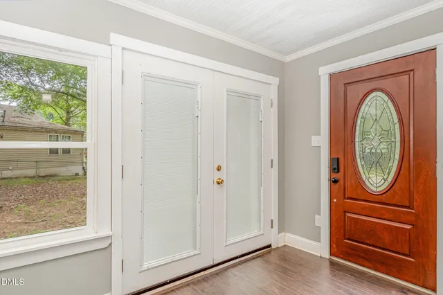 a view of a room with wooden floor and a ceiling fan