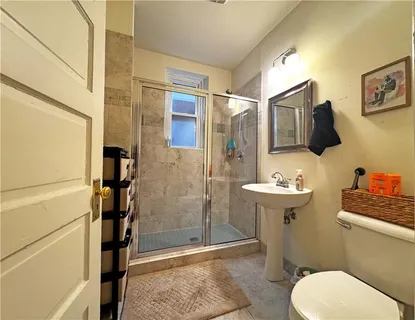 a bathroom with a sink toilet and shower