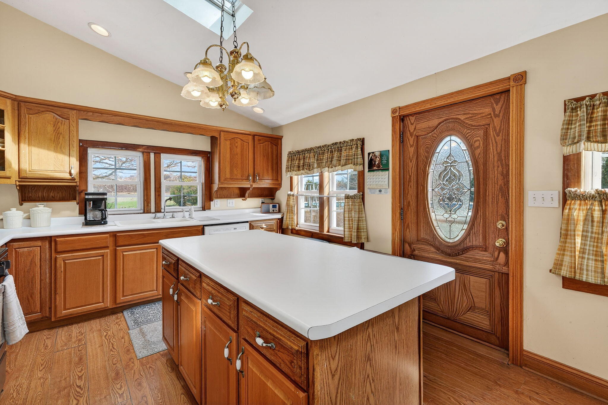 11403 Highway 10 Argos, IN 46501 - Photo 5 of 50 a kitchen with a wooden table a clock two sink and a large window
