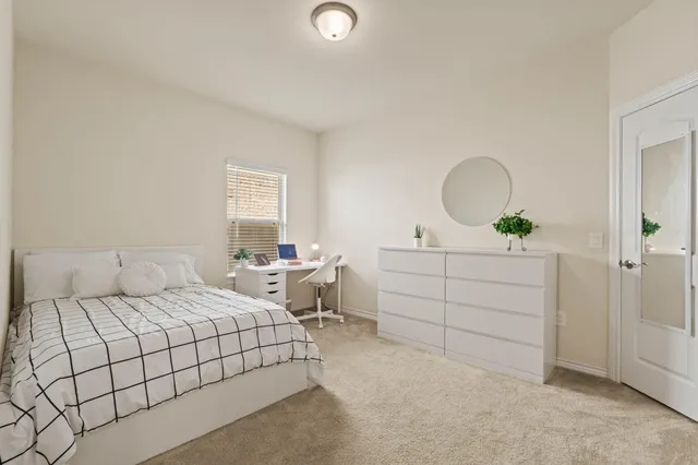 a bedroom with a bed and a dresser