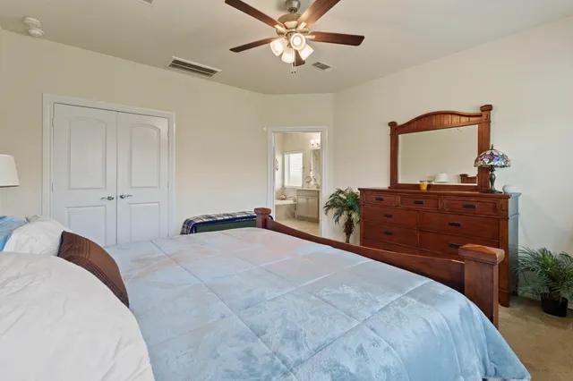a bedroom with a bed and a dresser