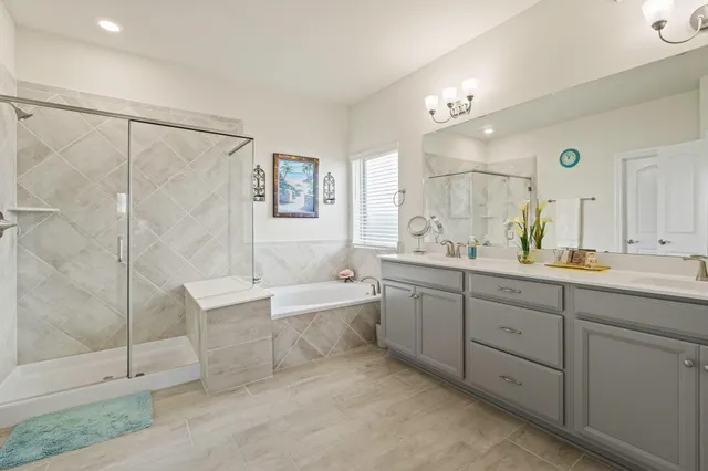 a spacious bathroom with a double vanity sink mirror and shower