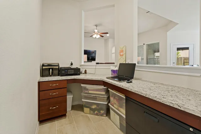 a kitchen with a granite countertop cabinets and chandelier