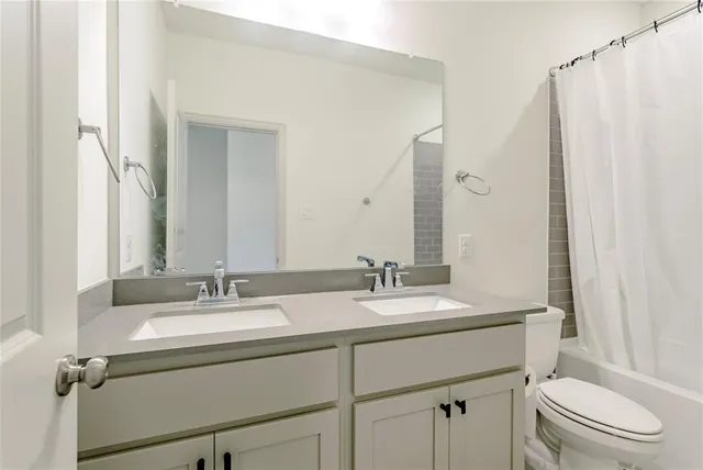 a bathroom with a granite countertop sink double and mirror