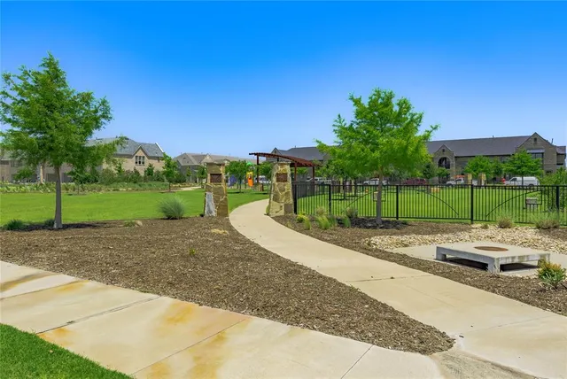 a front view of a house with a garden and plants