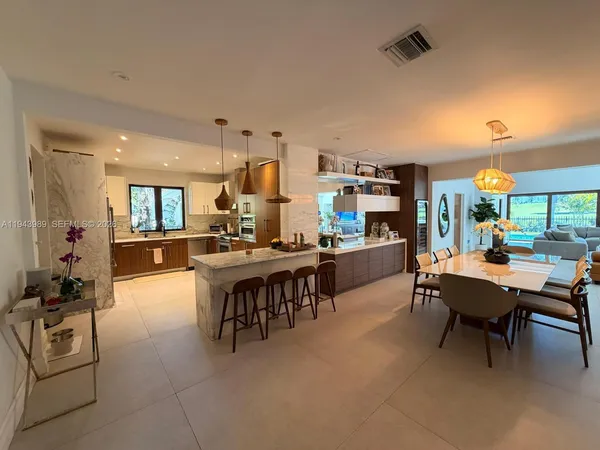 a view of a tennis ground with large trees