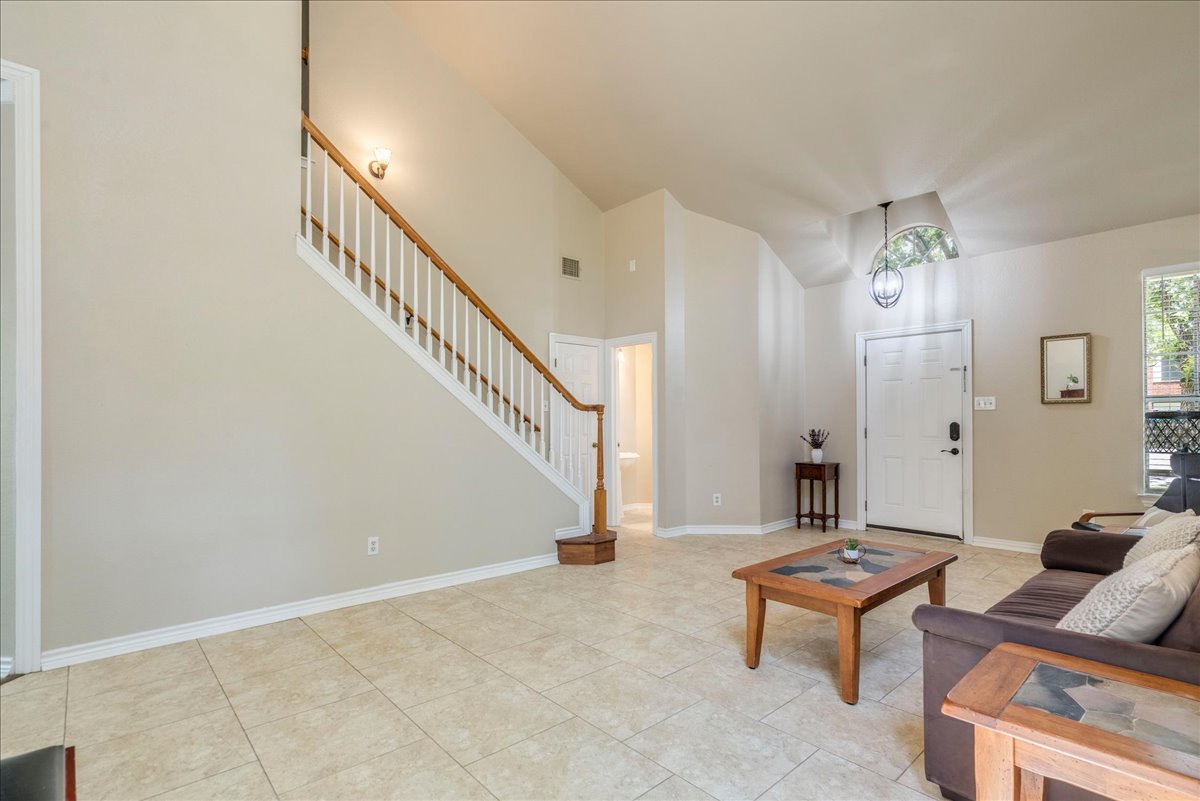 9300 Tea Rose Trail Austin, TX 78748 - Photo 8 of 33 Upon entering, a high ceiling and a prominent staircase greet you in this welcoming living space.