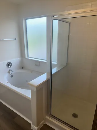 a bathroom with a tub and a shower