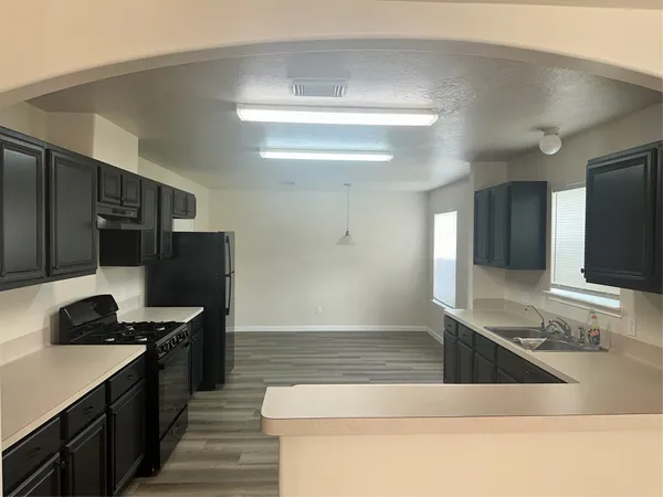 a kitchen with stainless steel appliances granite countertop a sink and a stove