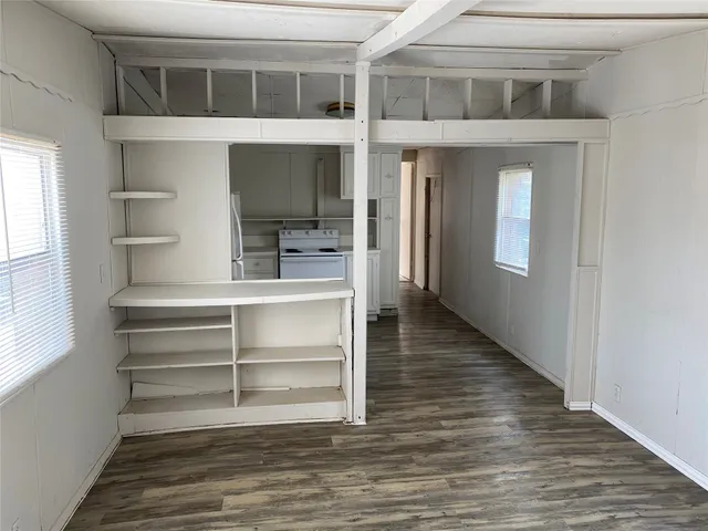 a view of room with window and wooden floor
