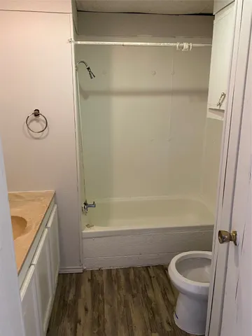 a bathroom with a granite countertop bathtub shower