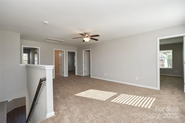 a view of a room with a ceiling fan