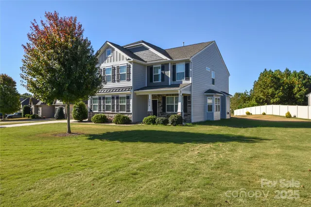 a front view of a house with a yard table and garage