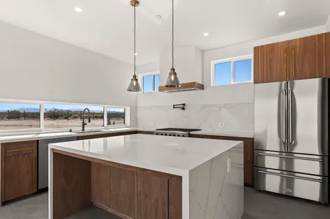 a kitchen with a sink stove and refrigerator