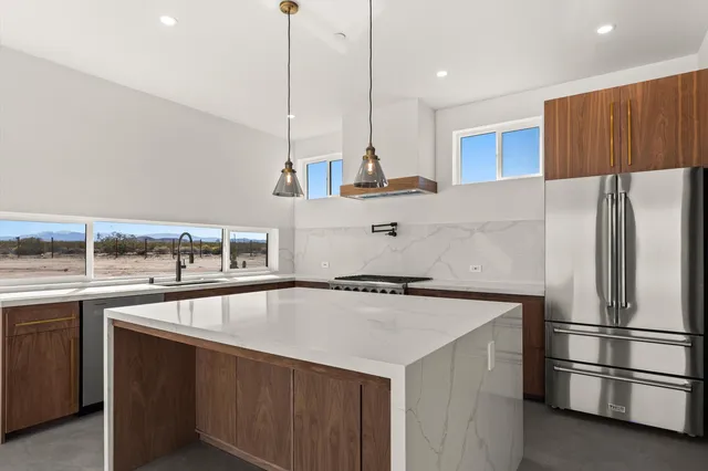 a kitchen with a sink stove and refrigerator