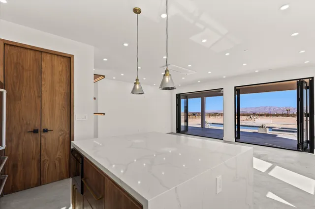 a large kitchen with a table and chairs