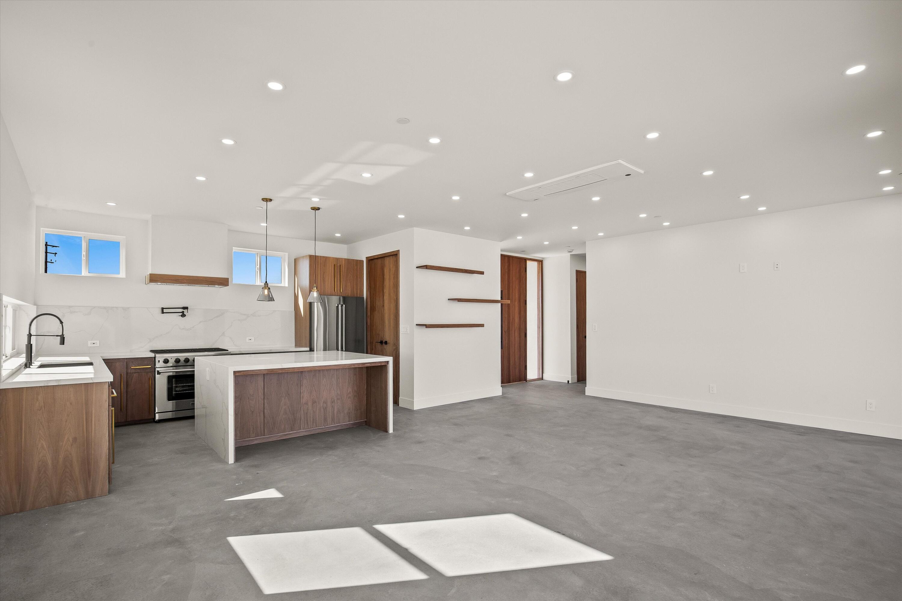 1925 Border Avenue Joshua Tree, CA 92252 - Photo 18 of 60 a view of kitchen with stainless steel appliances kitchen island a stove a sink a refrigerator and a fireplace