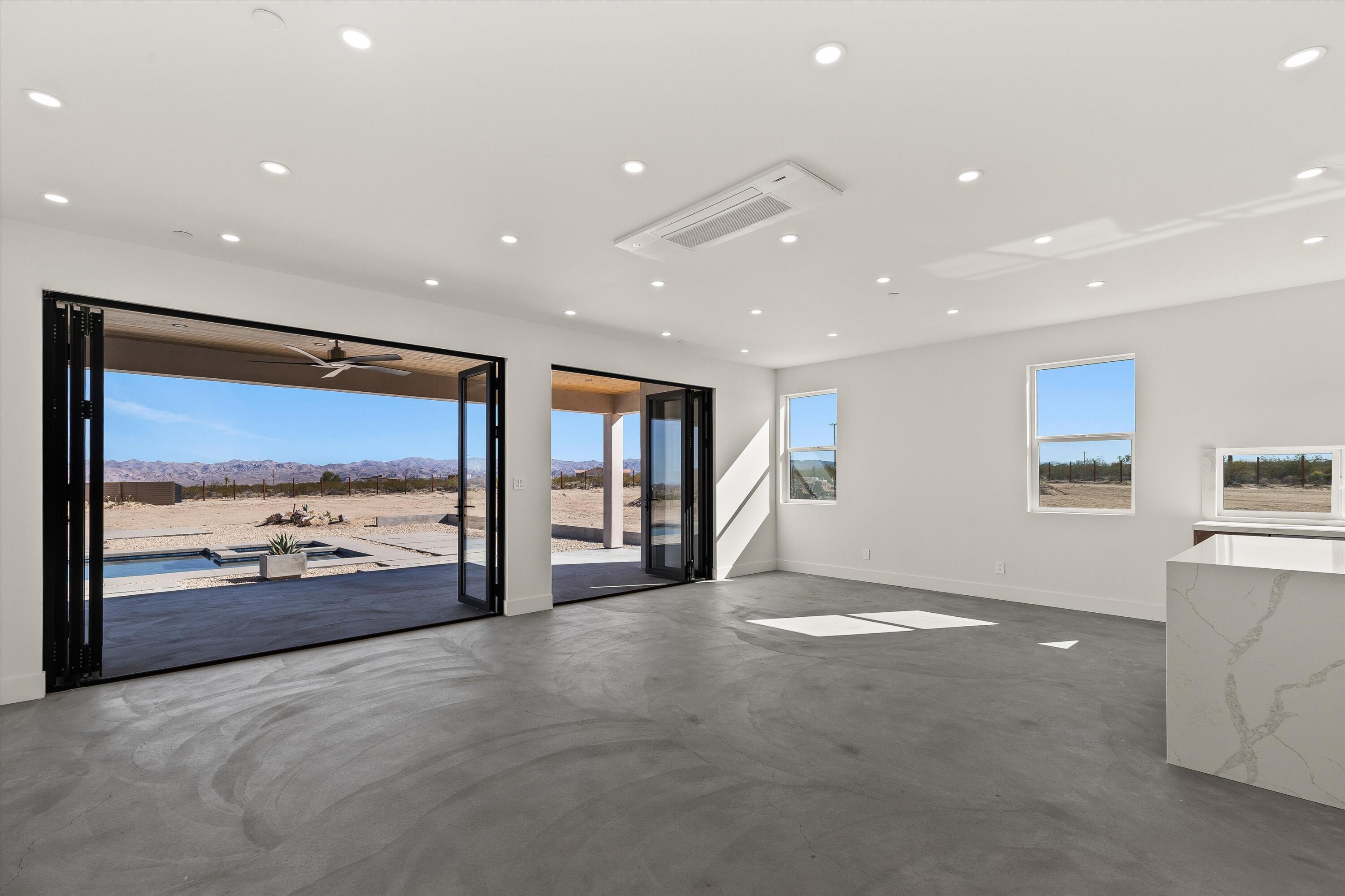 1925 Border Avenue Joshua Tree, CA 92252 - Photo 19 of 60 a view of a big room with windows and chandelier