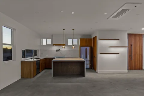 an empty room with a ceiling fan and wooden floor