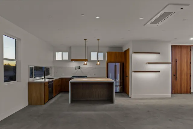 an empty room with a ceiling fan and wooden floor