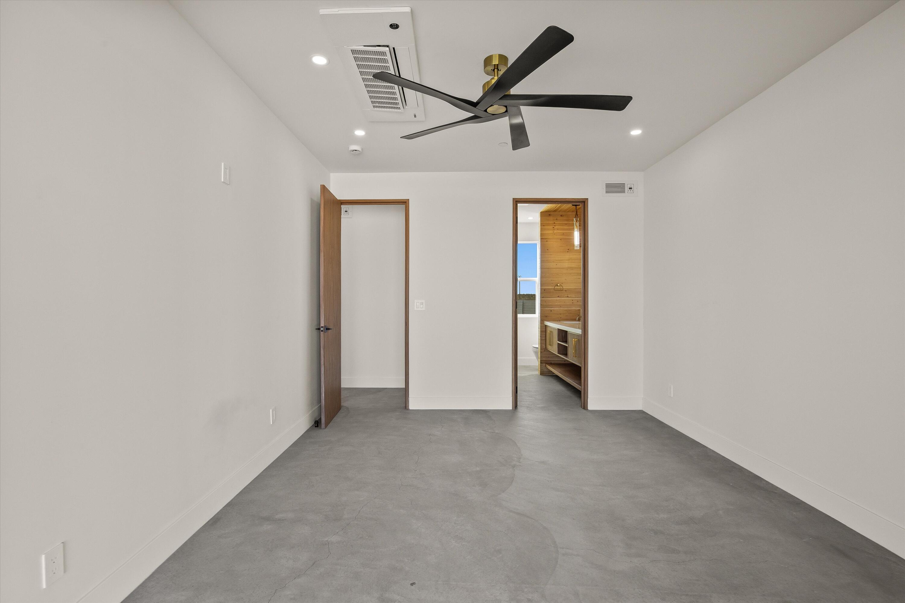 1925 Border Avenue Joshua Tree, CA 92252 - Photo 31 of 60 an empty room with a ceiling fan and wooden floor