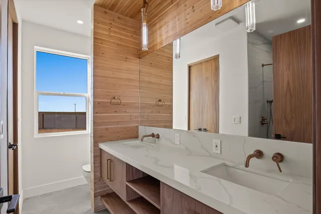 an empty room with a ceiling fan and a window
