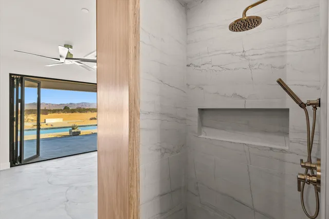 an empty room with a ceiling fan and a window