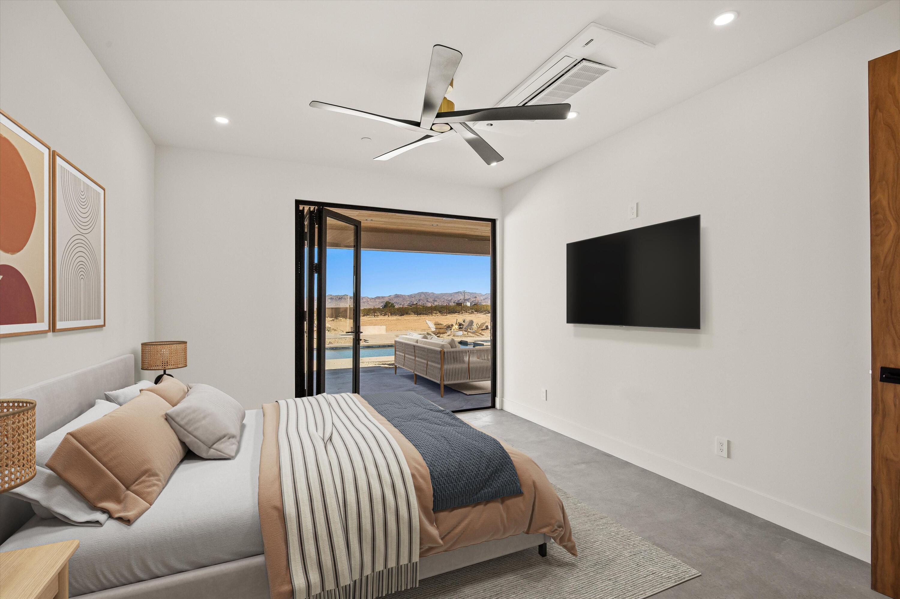 1925 Border Avenue Joshua Tree, CA 92252 - Photo 36 of 60 a bedroom with a bed and a flat screen tv