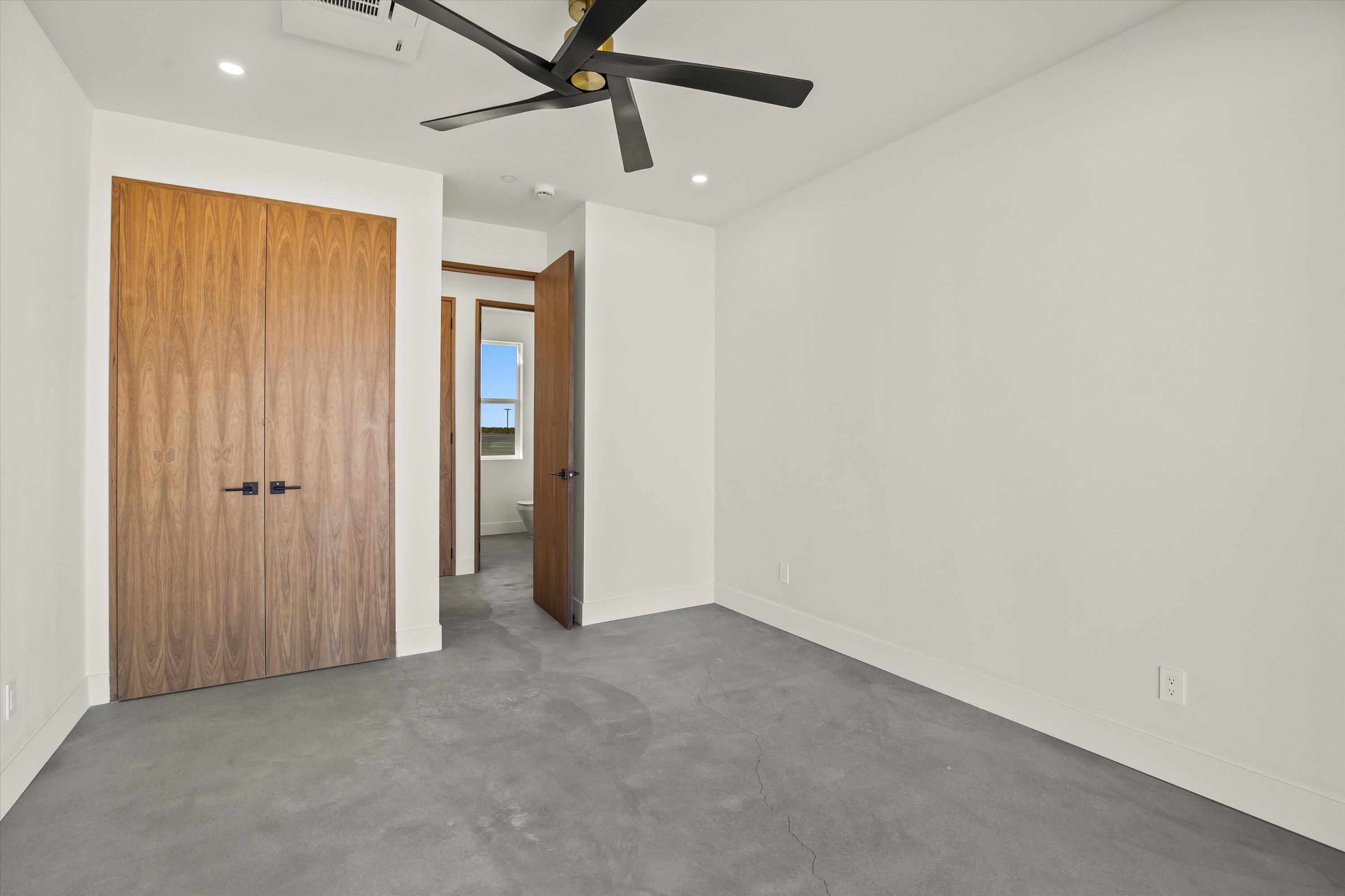 1925 Border Avenue Joshua Tree, CA 92252 - Photo 38 of 60 an empty room with a ceiling fan and a window