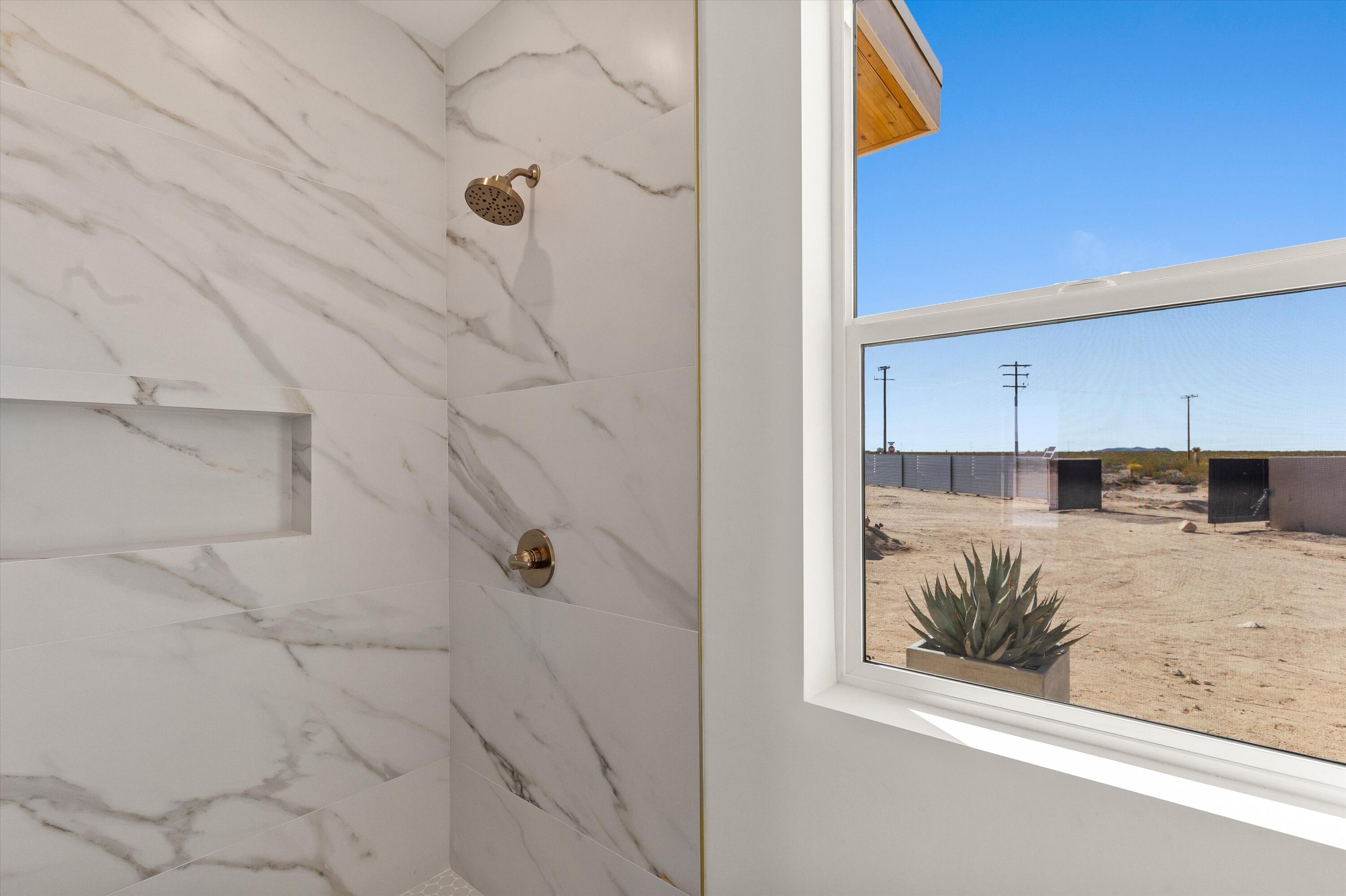 1925 Border Avenue Joshua Tree, CA 92252 - Photo 40 of 60 a bathroom with a bathtub and shower