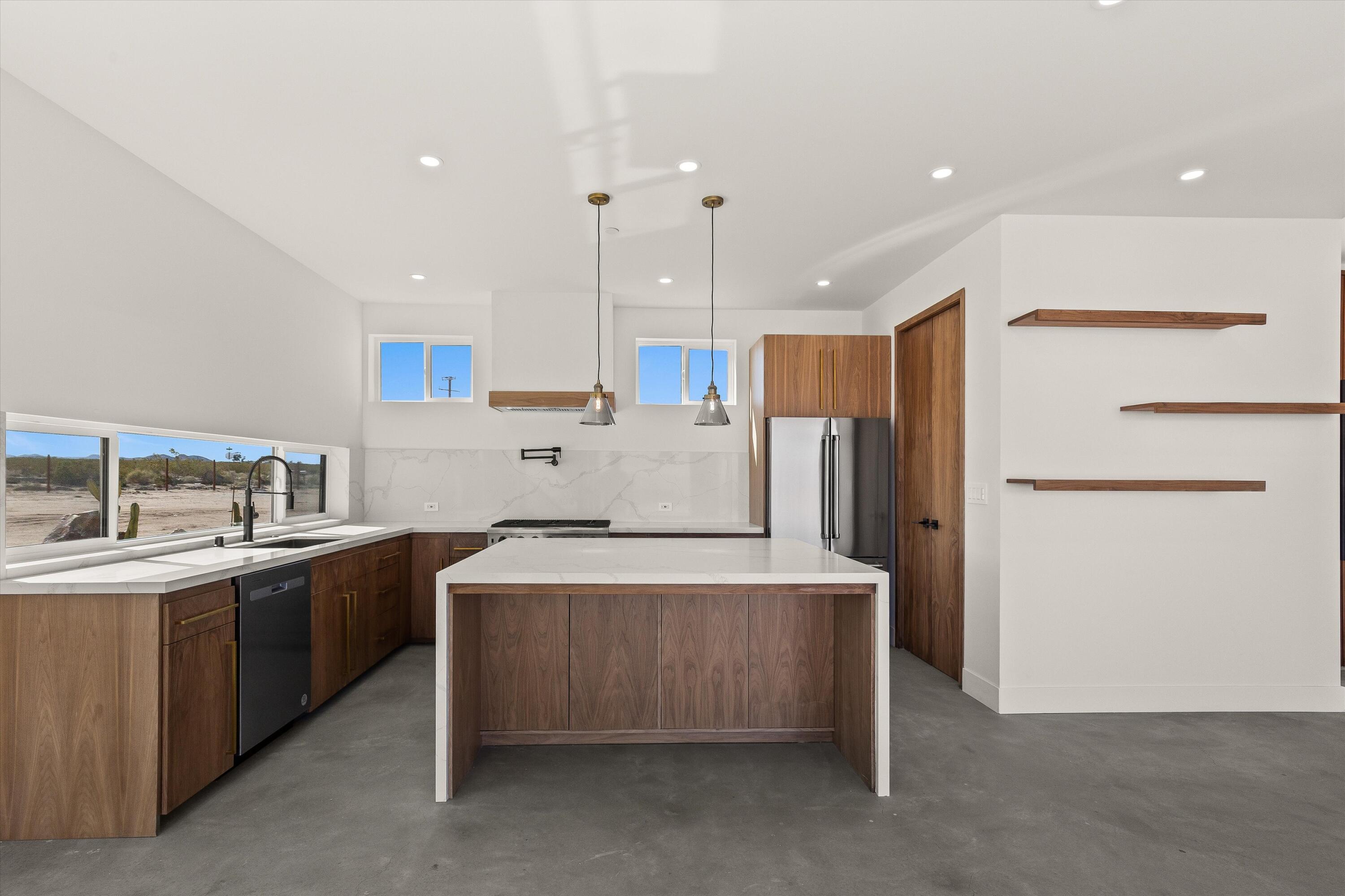 1925 Border Avenue Joshua Tree, CA 92252 - Photo 41 of 60 a kitchen with stainless steel appliances a sink a stove a refrigerator and cabinets