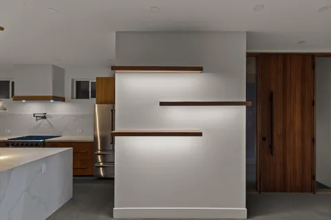 a kitchen with a refrigerator and a stove top oven