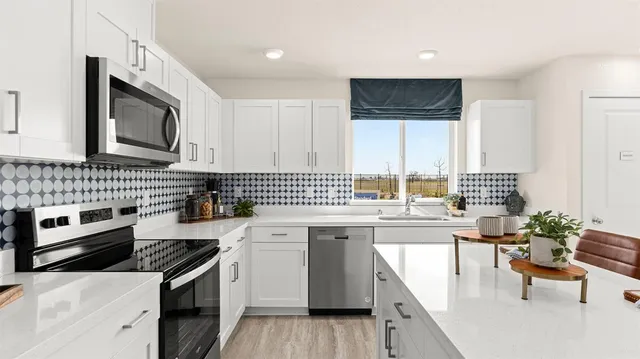 a kitchen with a sink stove and microwave