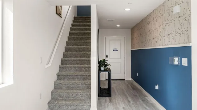 a view of an entryway with wooden floor