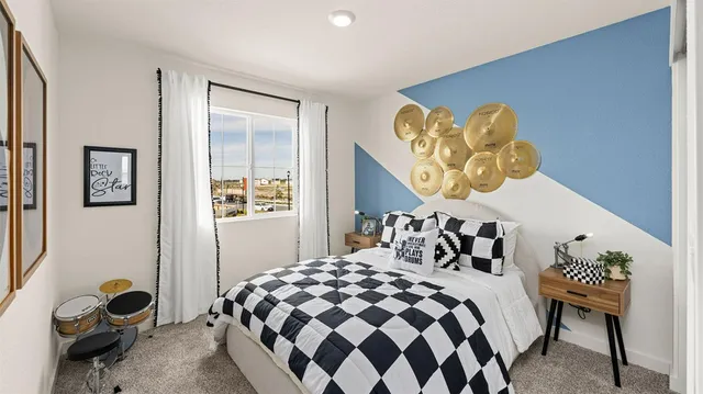 a bedroom with a bed and painting on the wall