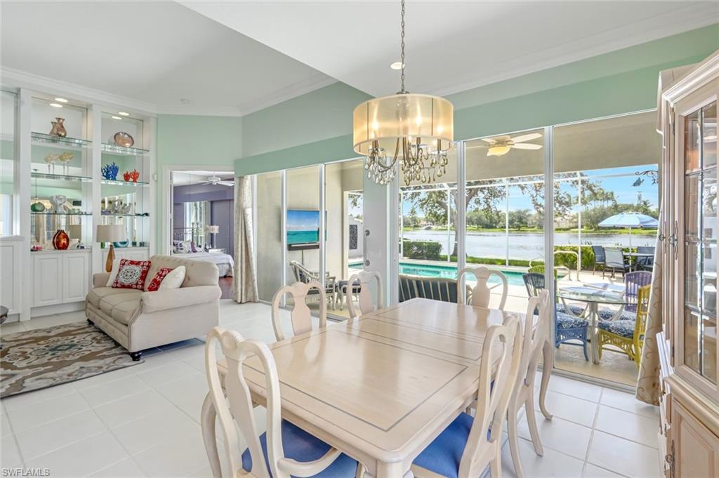 3794 Whidbey Way Naples, FL 34119 - Photo 14 of 46 a view of a dining room with furniture wooden floor and chandelier